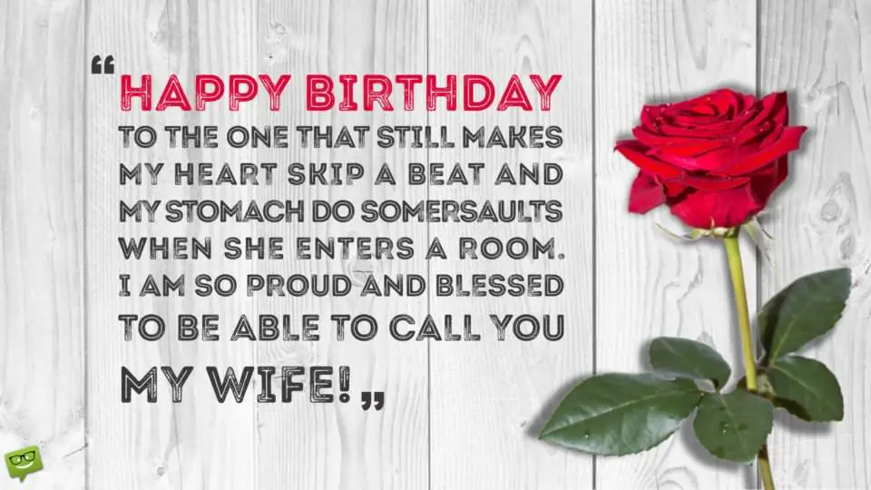 Romantic Birthday Wish for my wife on image of red rose on a white wooden table.