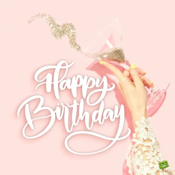 Stylish birthday image with female hand holding a champagne glass full of glitter. Birthday image for stylish friend.