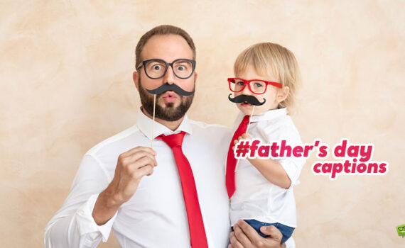 Featured image for an article with father's day captions. On the image we see a handsome father with his child, both putting on funny mustaches on their faces.